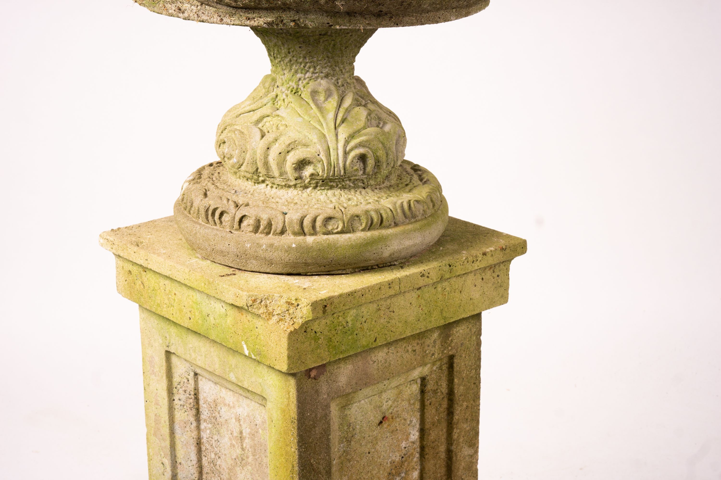 A pair of reconstituted stone circular garden planters on pedestal bases, diameter 45cm, height 110cm